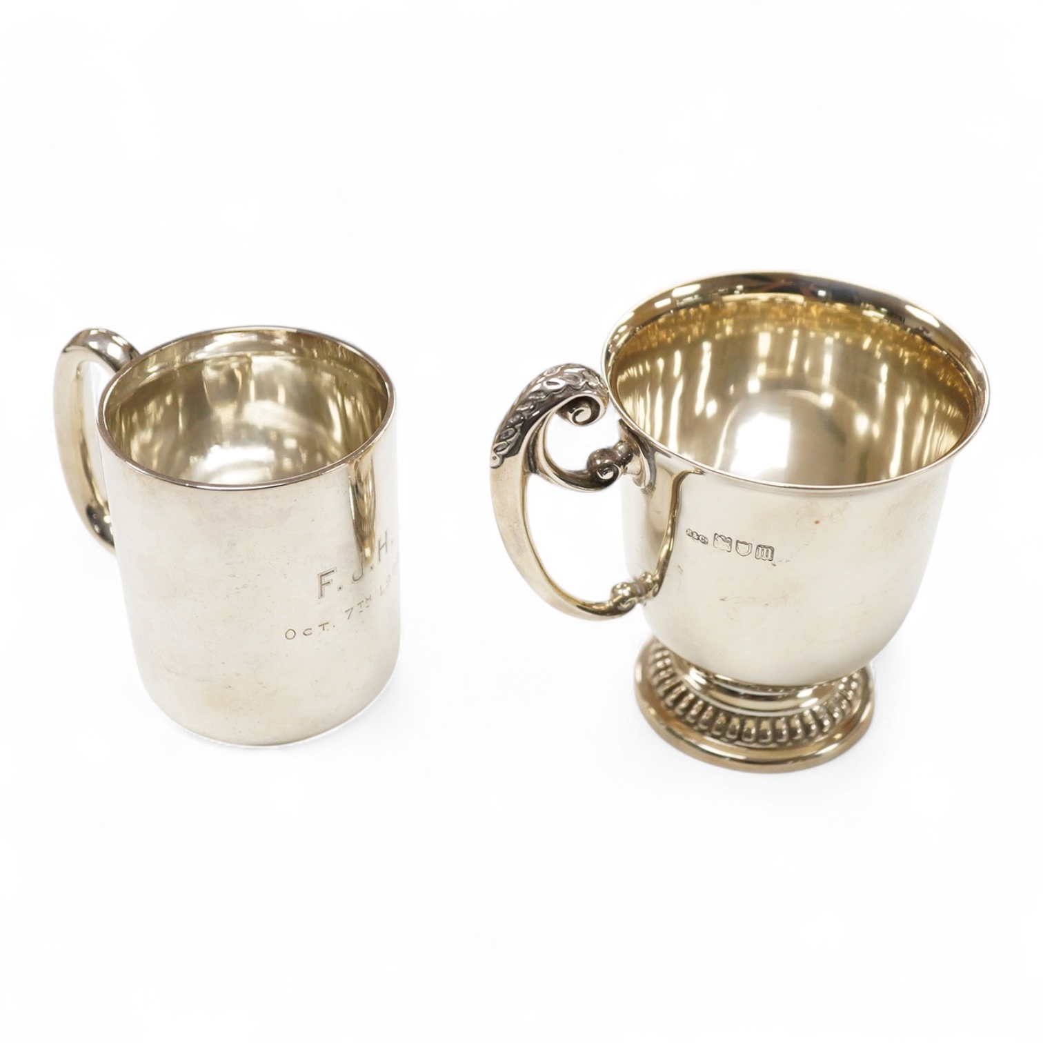 An Edwardian silver christening mug, wit engraved initials, Robinson & Co Ltd, London, 1907, height 99mm and one other smaller silver christening mug, James Dixon & Sons, Sheffield, 1907, 8.3oz.
